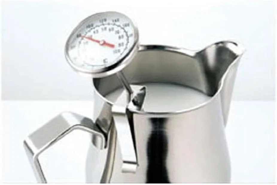 Stainless steel milk thermometer clipped to a frothing pitcher