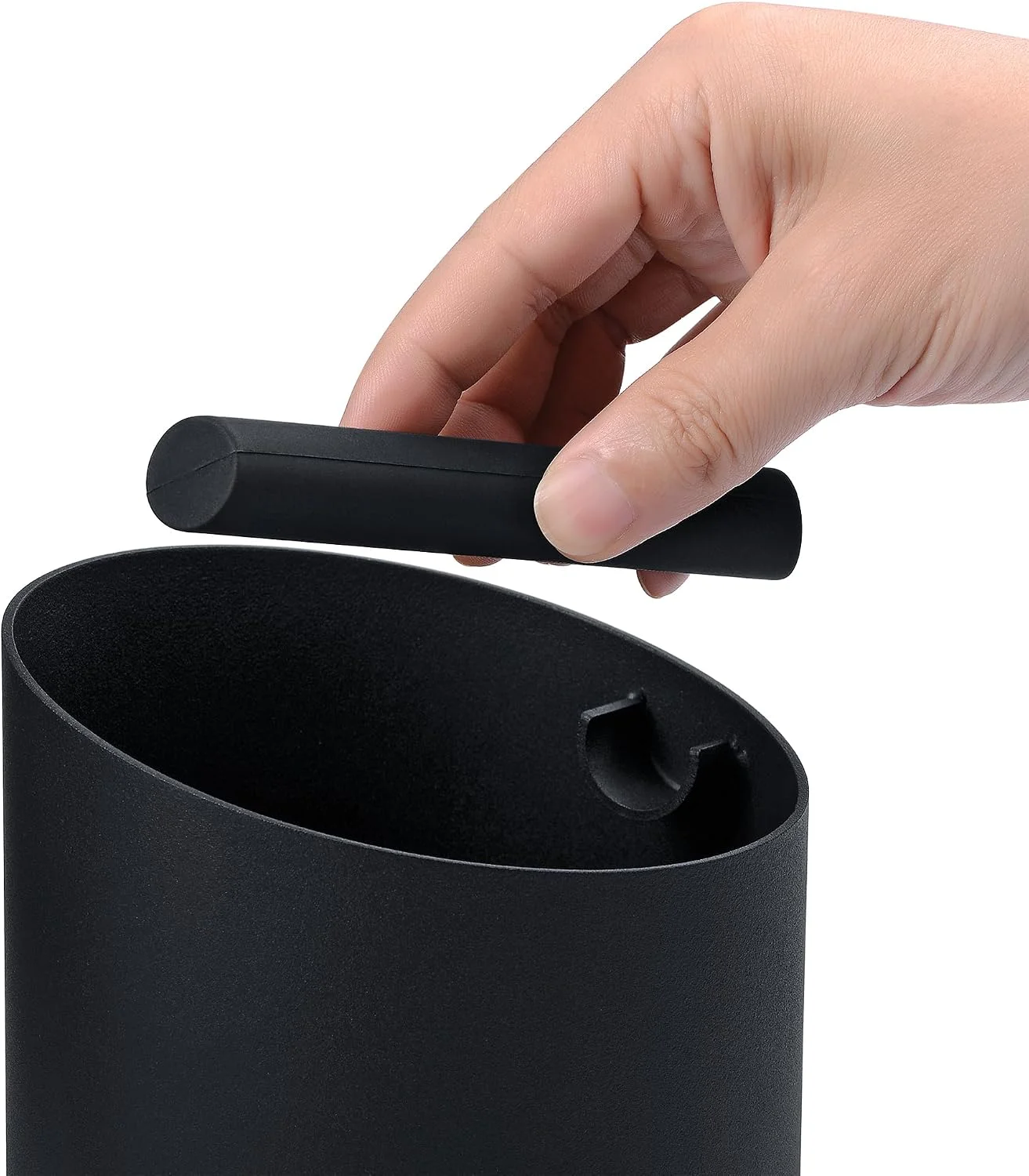 Coffee grounds being knocked into the bin without mess
